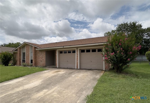 1804 Kingman Rd, Killeen, TX 76549 - view of front of house featuring driveway, an attached garage, brick siding, and a front lawn
