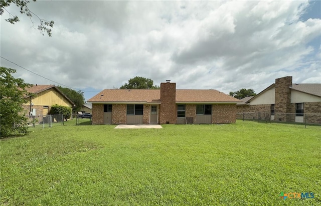 1804 Kingman Rd, Killeen, TX 76549 - rear view of property featuring a chimney, a patio area, brick siding, a fenced backyard, and a shingled roof