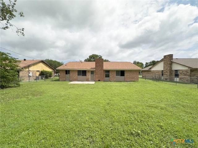 1804 Kingman Rd, Killeen, TX 76549 - back of house with a patio area, a chimney, brick siding, and a fenced backyard