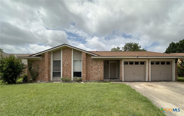 1804 Kingman Rd, Killeen, TX 76549 - view of front of house with a garage, concrete driveway, brick siding, and a front lawn