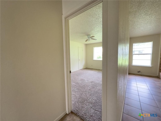 1804 Kingman Rd, Killeen, TX 76549 - hall with a textured ceiling, carpet floors, and tile patterned floors