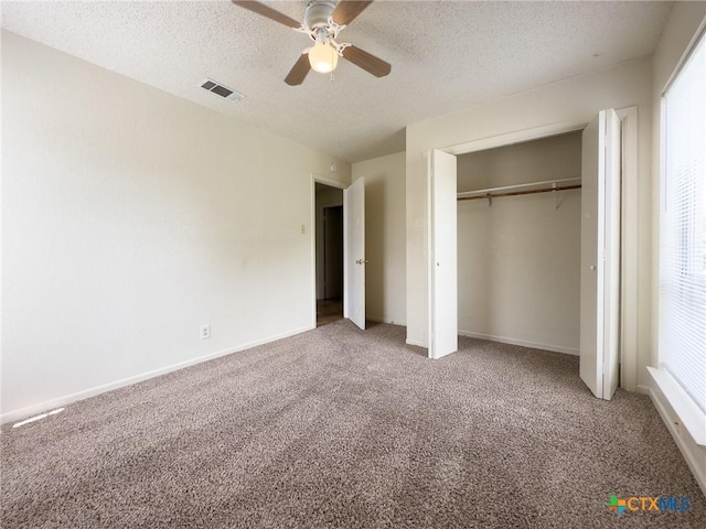 1804 Kingman Rd, Killeen, TX 76549 - unfurnished bedroom featuring carpet floors, a textured ceiling, multiple windows, a closet, and ceiling fan