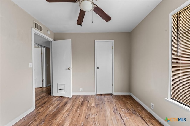 3105 Julie Ln, Killeen, TX 76549 - unfurnished bedroom with wood finished floors, baseboards, and a ceiling fan