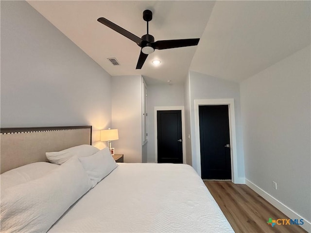 bedroom featuring hardwood / wood-style flooring, ceiling fan, and lofted ceiling