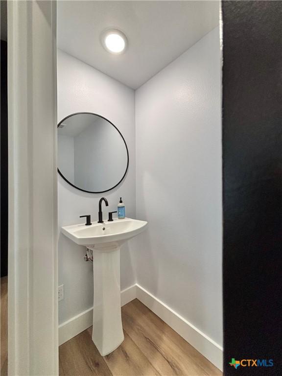 bathroom with hardwood / wood-style floors