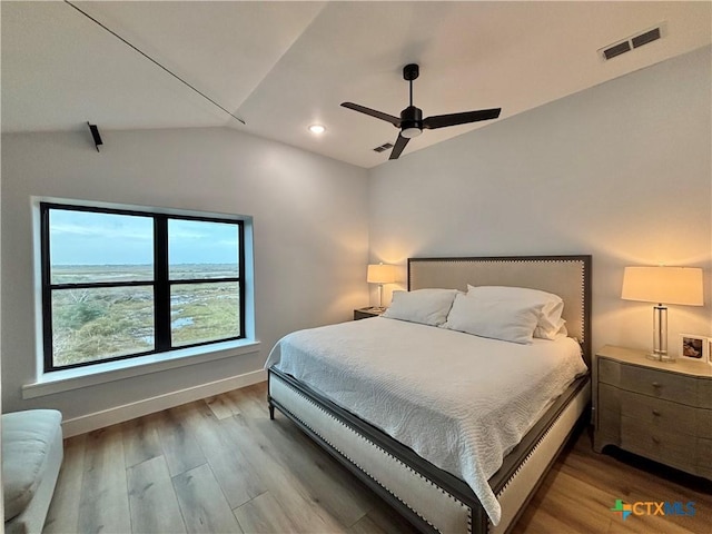 bedroom featuring ceiling fan, vaulted ceiling, and wood-type flooring