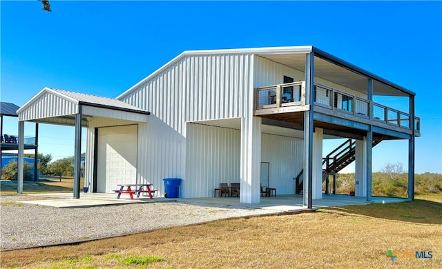 back of property featuring a garage and a yard