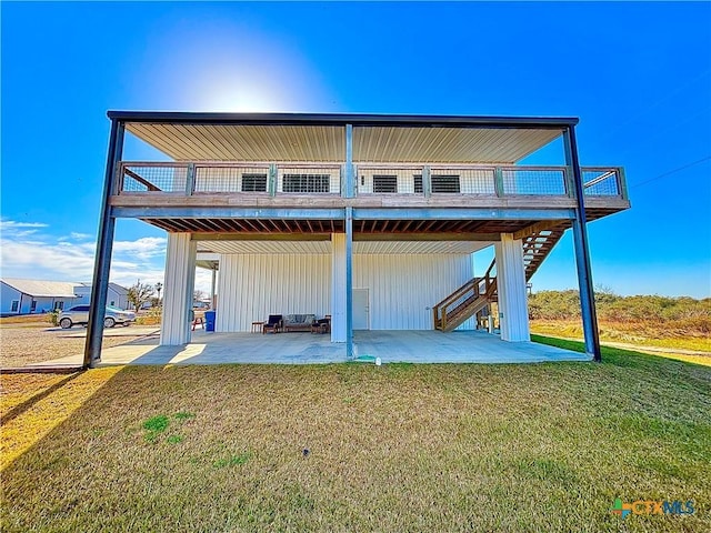 back of property featuring a patio and a lawn