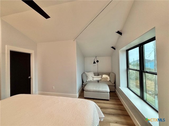 bedroom with light hardwood / wood-style flooring and vaulted ceiling