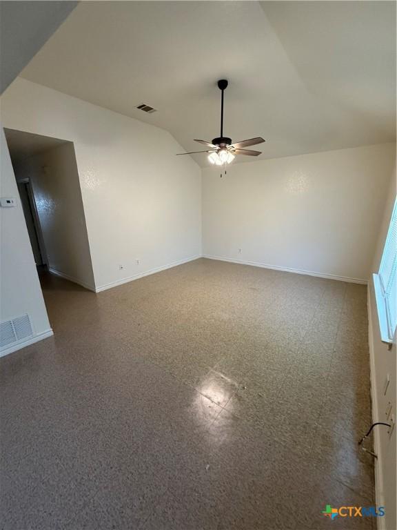 705 N 2nd St, Temple, TX 76501 - empty room featuring baseboards, ceiling fan, and vaulted ceiling