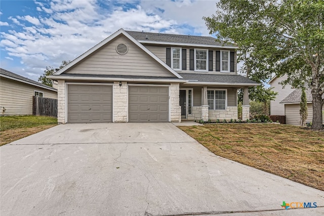 view of front of property featuring a garage and a front yard