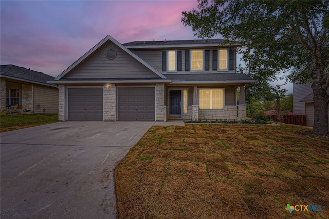 view of front of home with a garage, a porch, and a lawn