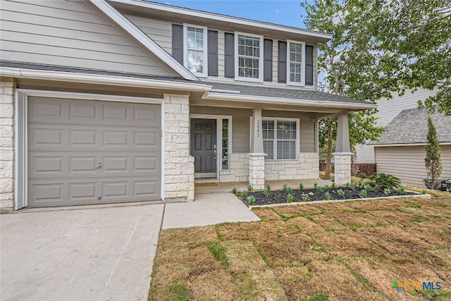 view of front facade with a garage and covered porch