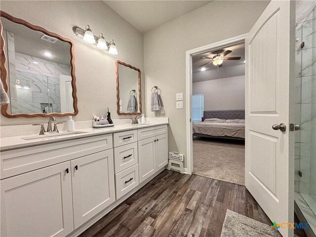 109 Opal Way, Port Lavaca, TX 77979 - ensuite bathroom featuring double vanity, a marble finish shower, wood finished floors, and ceiling fan