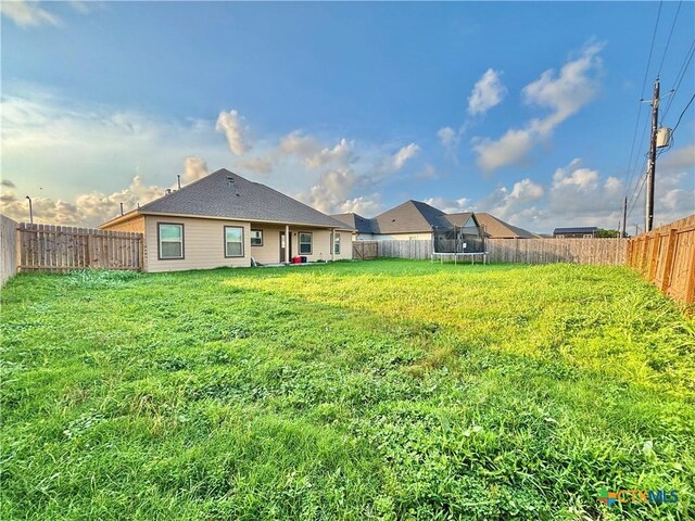 109 Opal Way, Port Lavaca, TX 77979 - rear view of property featuring a trampoline