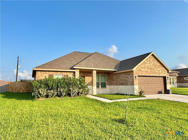 109 Opal Way, Port Lavaca, TX 77979 - view of front of property featuring an attached garage, brick siding, driveway, and roof with shingles