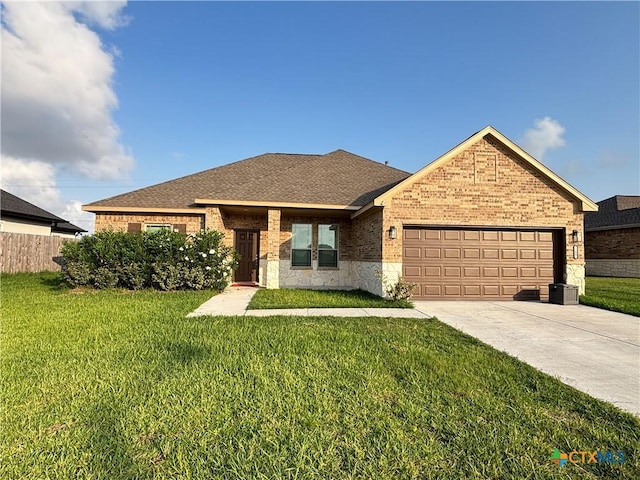 109 Opal Way, Port Lavaca, TX 77979 - ranch-style house featuring brick siding, a garage, driveway, a shingled roof, and stone siding
