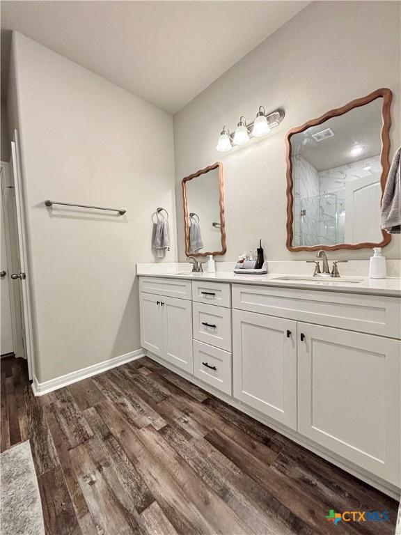 109 Opal Way, Port Lavaca, TX 77979 - full bath featuring double vanity, tiled shower, wood finished floors, and baseboards