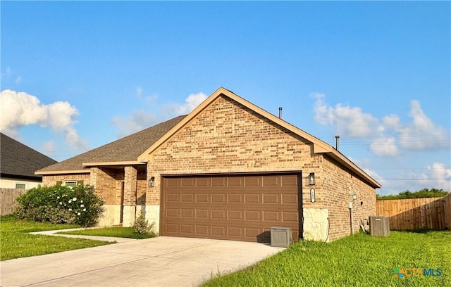 109 Opal Way, Port Lavaca, TX 77979 - ranch-style house featuring brick siding, an attached garage, concrete driveway, central AC unit, and roof with shingles