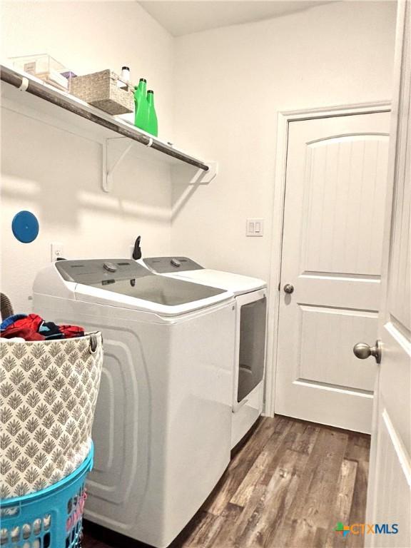 109 Opal Way, Port Lavaca, TX 77979 - washroom with washing machine and clothes dryer and dark wood-type flooring