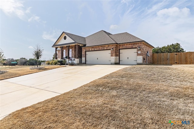 view of front of property with a garage and a front yard