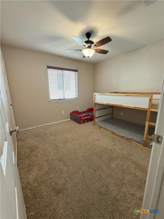 unfurnished bedroom featuring ceiling fan and carpet flooring