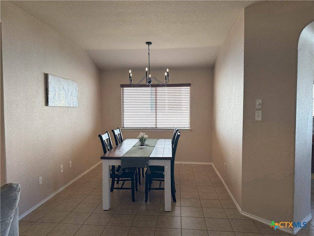 dining area featuring an inviting chandelier and tile patterned flooring