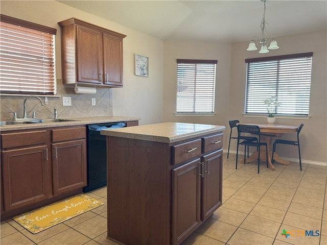 kitchen featuring dishwasher, light tile patterned floors, sink, a kitchen island, and backsplash