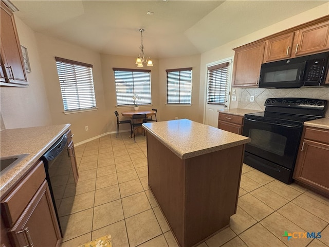 kitchen featuring black appliances, a center island, a chandelier, light tile patterned floors, and pendant lighting