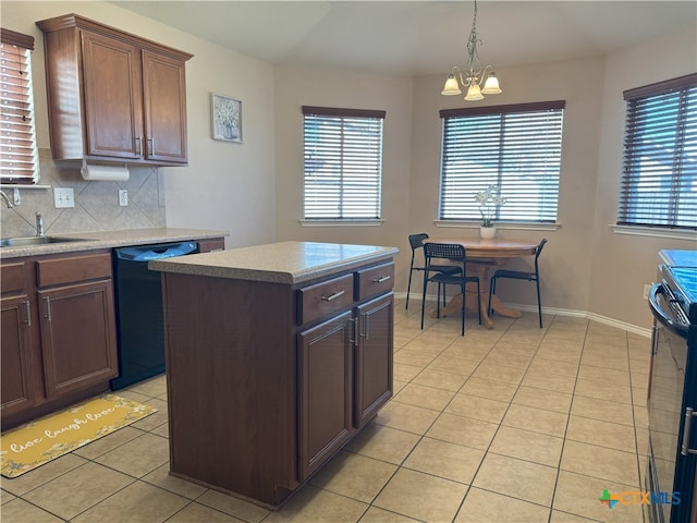 kitchen with light tile patterned flooring, black appliances, a center island, and decorative backsplash