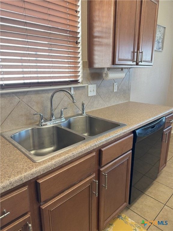 kitchen with sink, black dishwasher, decorative backsplash, and light tile patterned flooring