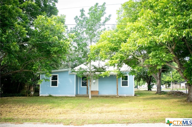 rear view of property featuring a yard