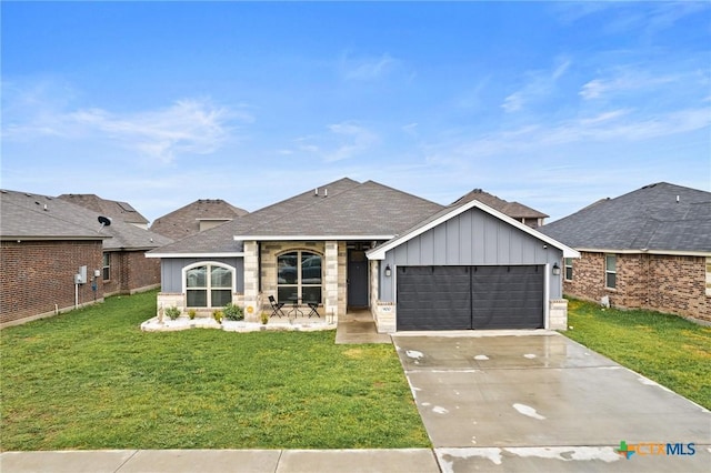 900 Holliday Dr, Killeen, TX 76542 - view of front of home with board and batten siding, a front lawn, an attached garage, and a shingled roof