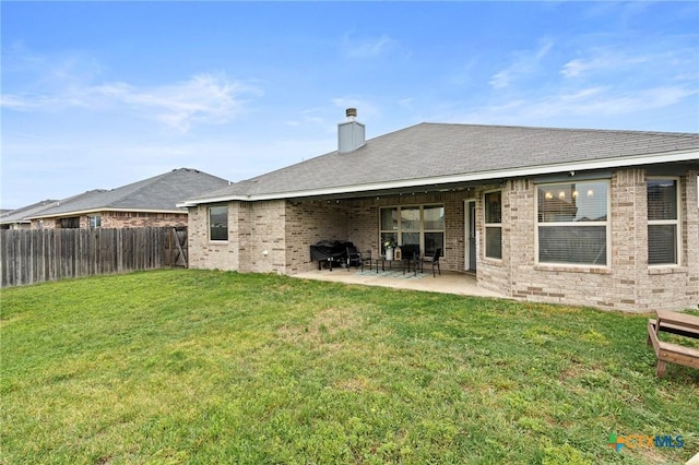 900 Holliday Dr, Killeen, TX 76542 - rear view of house featuring brick siding, a chimney, and a patio