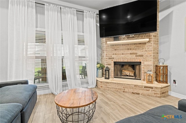 900 Holliday Dr, Killeen, TX 76542 - living area with baseboards, wood finished floors, and a brick fireplace