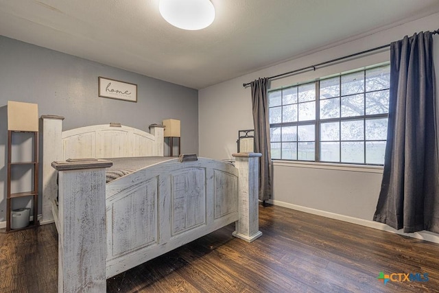 bedroom featuring baseboards and dark wood-type flooring