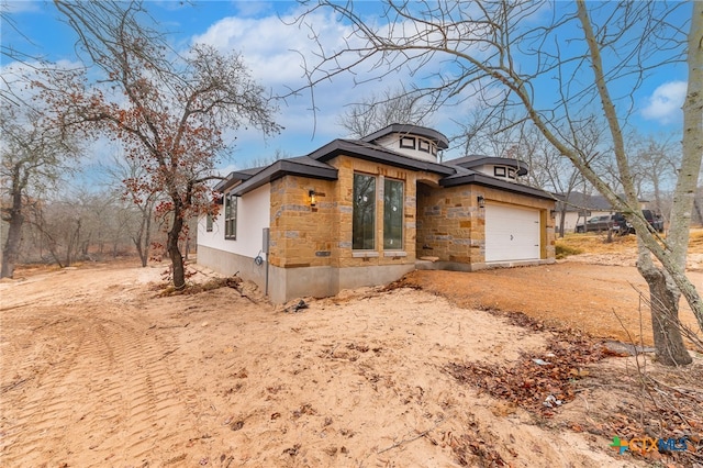 view of side of property with a garage