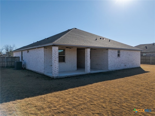 back of property featuring a yard, cooling unit, and a patio area