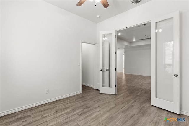 empty room featuring ceiling fan and light hardwood / wood-style floors