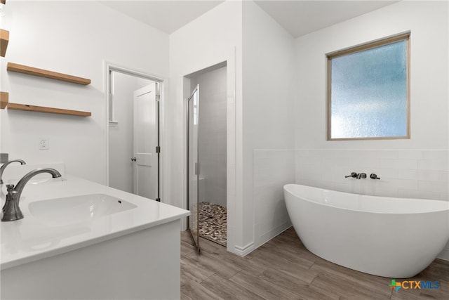 bathroom featuring vanity, wood-type flooring, and independent shower and bath