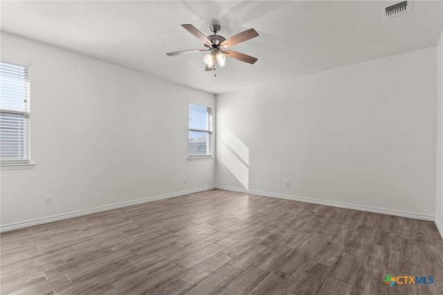 spare room featuring light hardwood / wood-style floors and ceiling fan