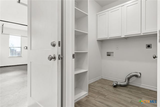 laundry area featuring cabinets, washer hookup, light hardwood / wood-style flooring, and electric dryer hookup