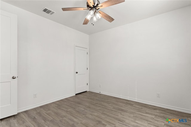 unfurnished room with ceiling fan and light wood-type flooring