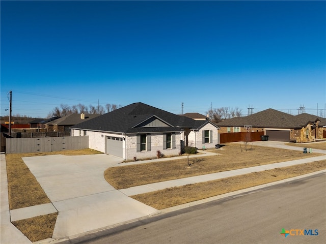 ranch-style house featuring a garage and a front yard