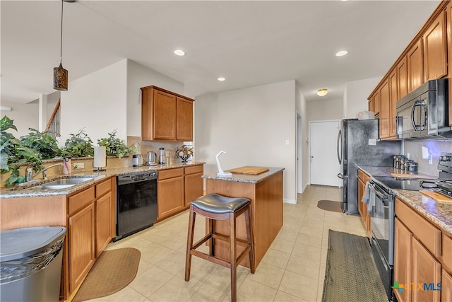 kitchen with black appliances, decorative backsplash, a kitchen island, and decorative light fixtures