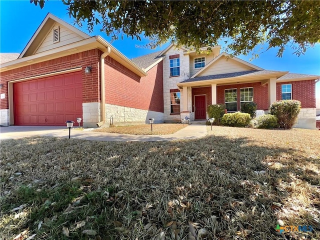 view of front facade featuring driveway, brick siding, and an attached garage