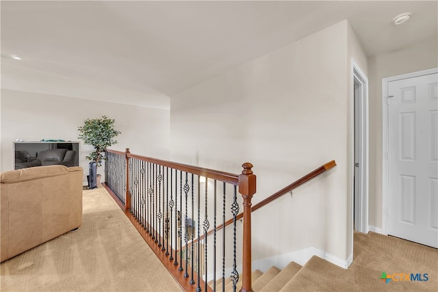 hallway featuring light carpet