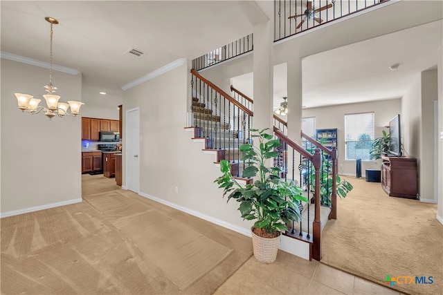 stairway featuring carpet, ornamental molding, and a chandelier