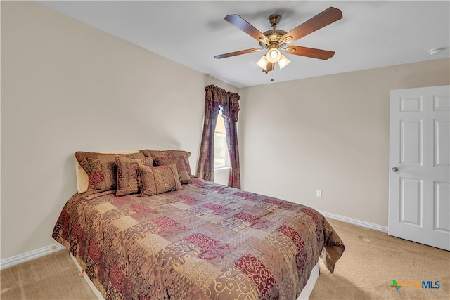 bedroom with ceiling fan and light carpet