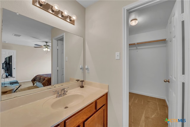 bathroom featuring ceiling fan and vanity